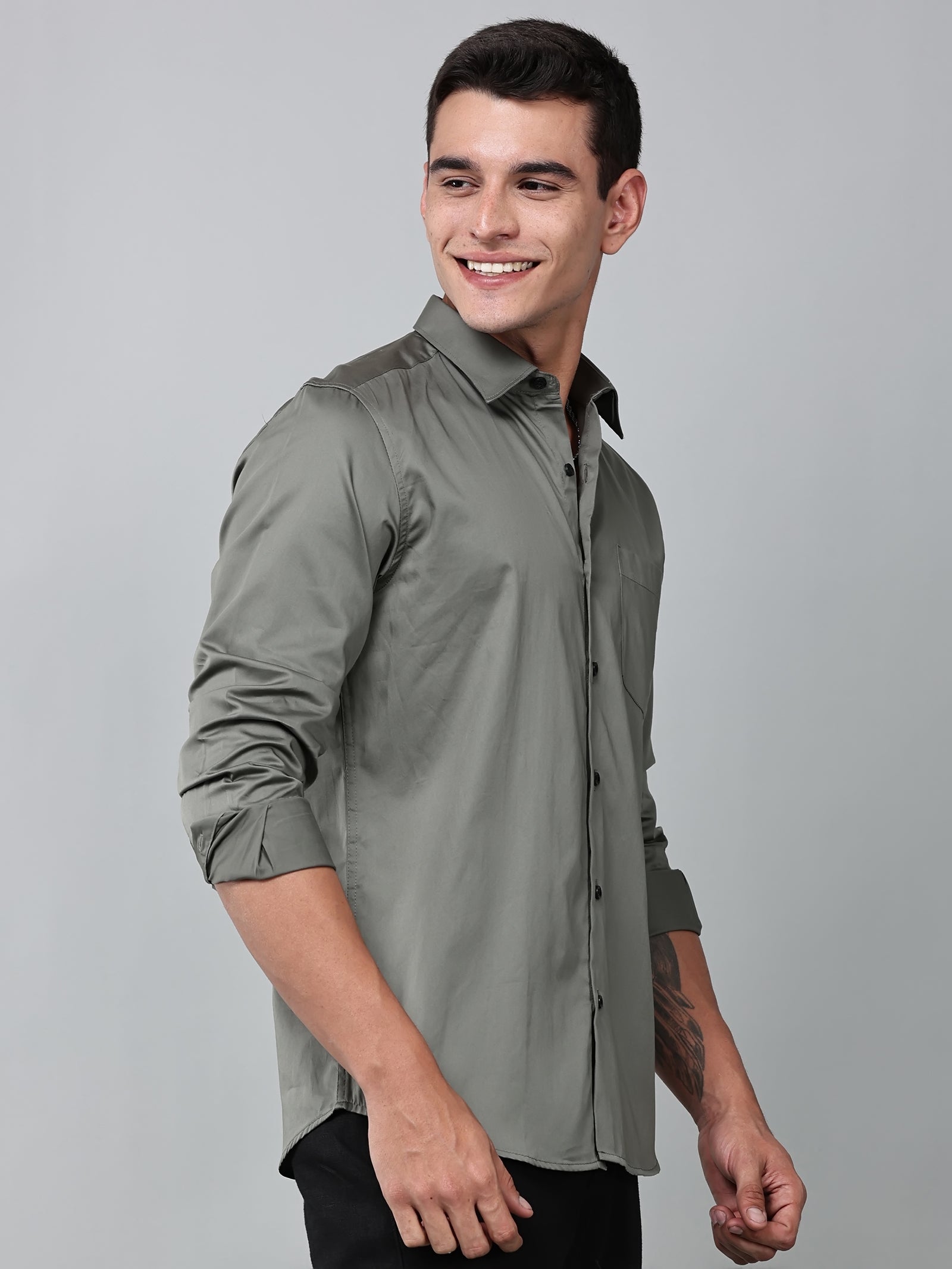 a model wearing a luxe satin olive green shirt