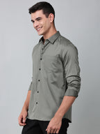 a model wearing a luxe satin olive green shirt