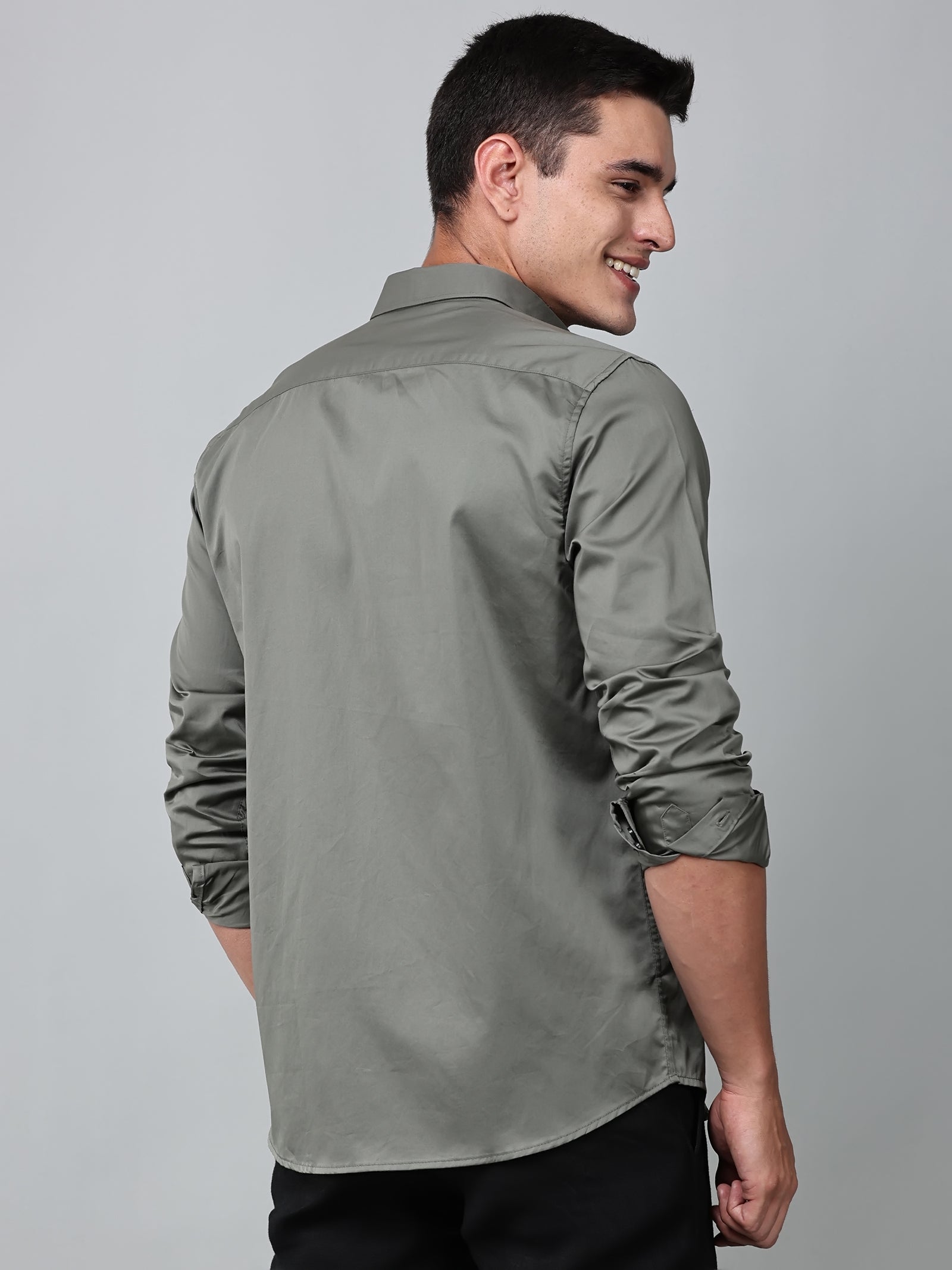 a model wearing a luxe satin olive green shirt