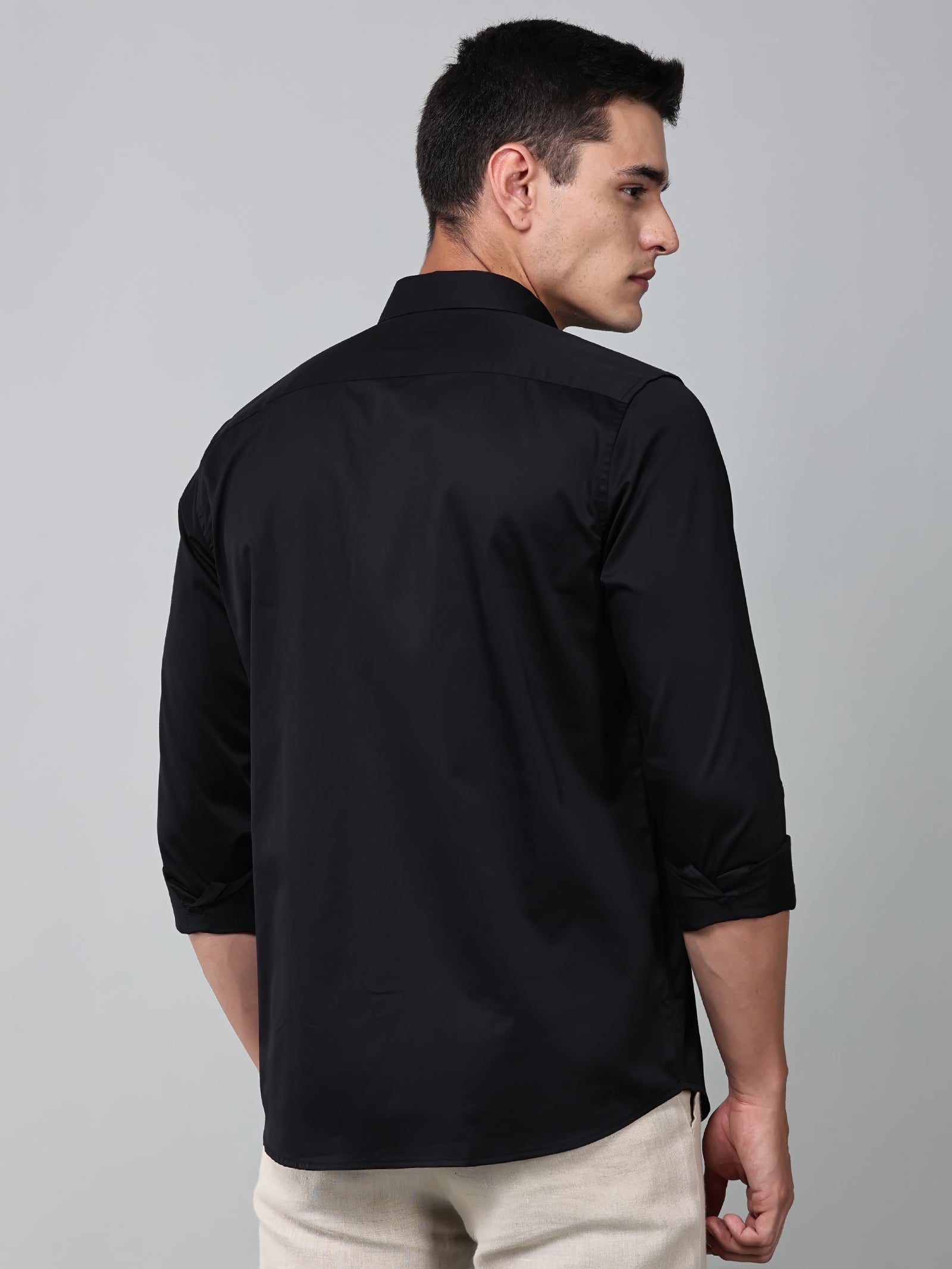 a model wearing a luxe satin black shirt