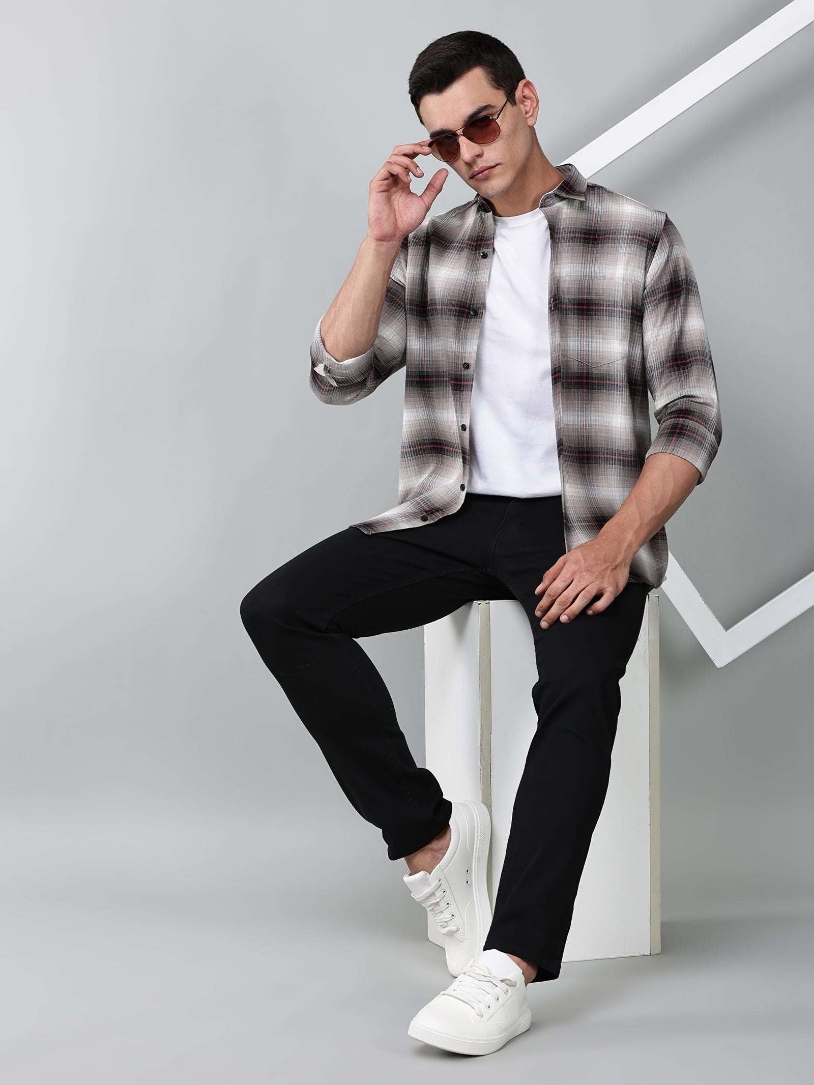 a model wearing a crimson (red) ombre checkered shirt with black trousers
