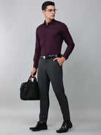 a model wearing a signature textured stretch formal purple shirt, with grey trousers, black formal shoes, and a laptop bag