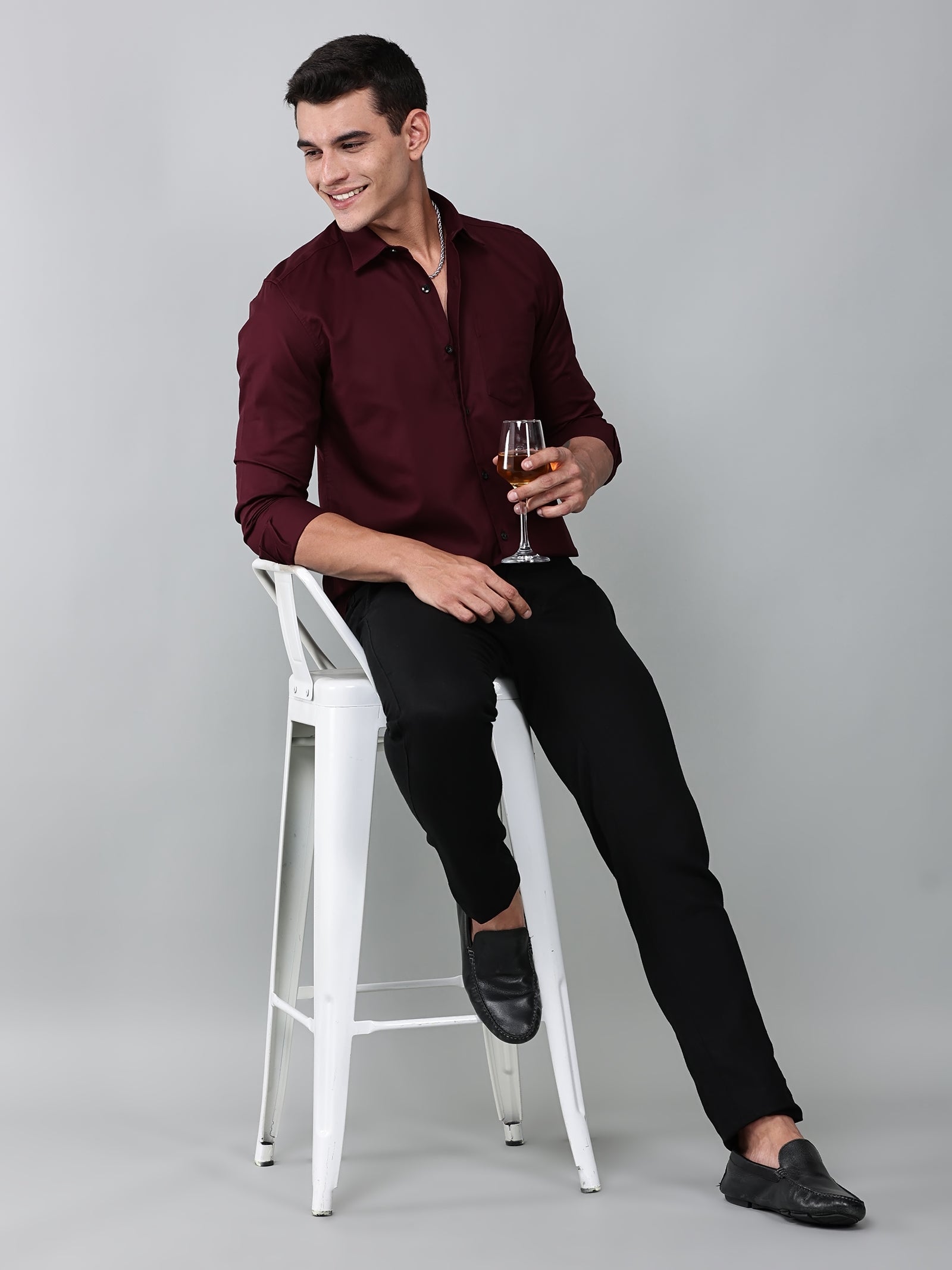 a model wearing a contour textured cherrywood shirt with black trousers and black loafers