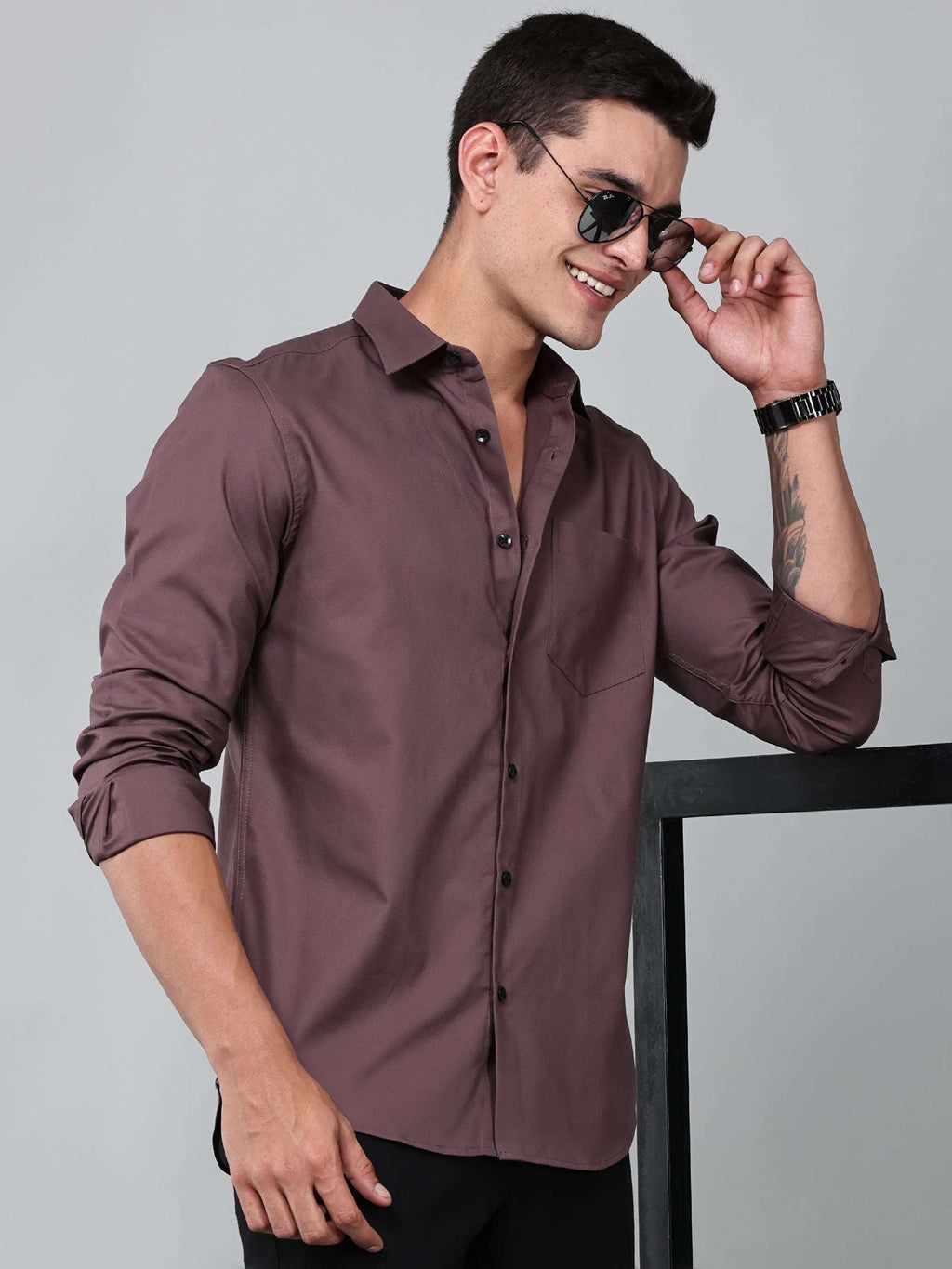 a model wearing a contour textured dusty rose shirt and sunglasses