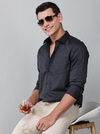 model wearing a luxe satin charcoal grey shirt holding a glass in one hand and wearing sunglasses