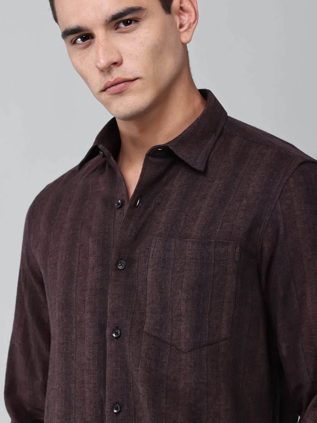 close up shot of a model wearing a midnight noir (black) maroon shirt