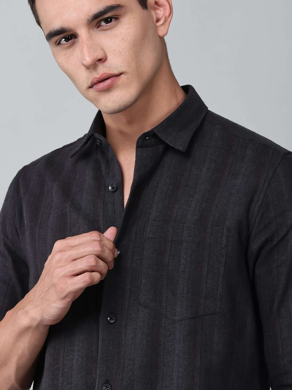 close up shot of a model wearing a midnight noir (black) obsidian shirt