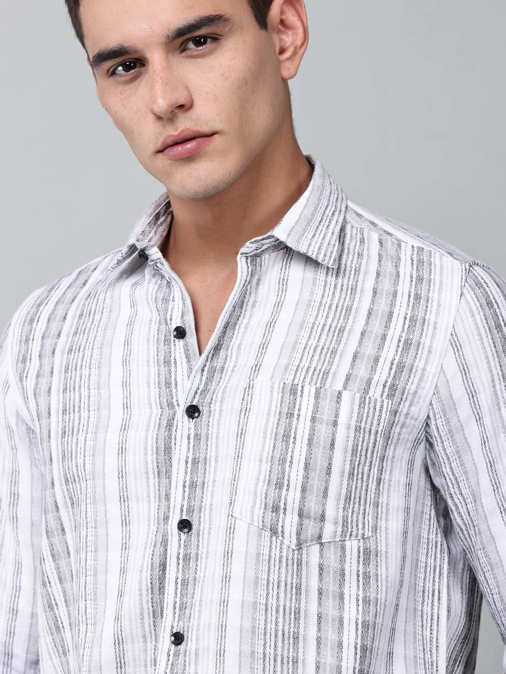 close up shot of a model wearing a white and charcoal textured stripe shirt