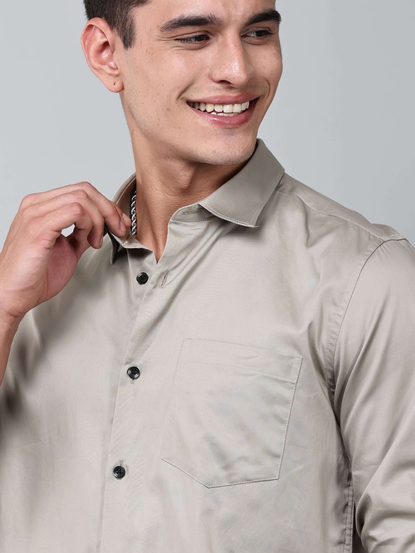 close up shot of a model wearing a luxe satin ivory stone shirt