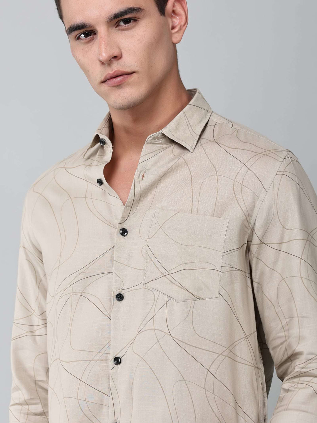 close up shot of the model wearing a linear drift sketch beige shirt