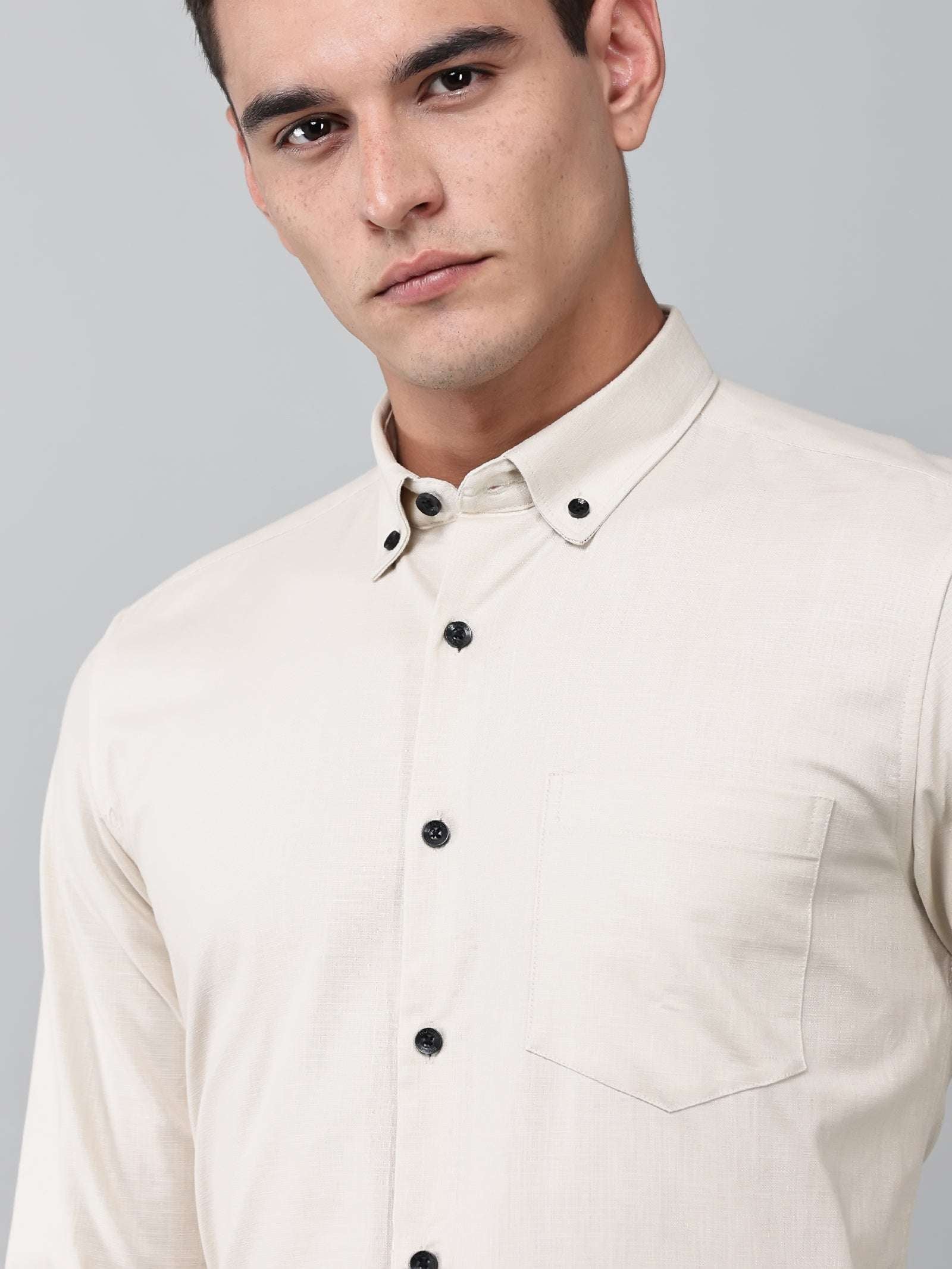 close up shot of a model wearing a beige heritage linen luxe shirt
