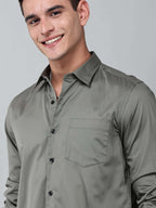 close up shot of a model wearing a luxe satin olive green shirt