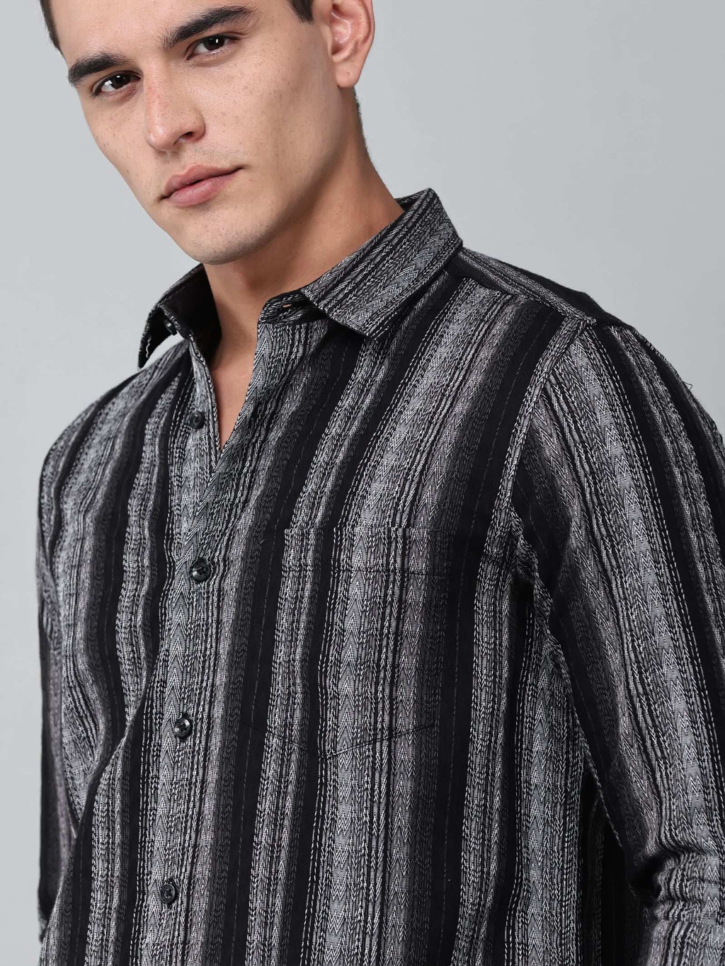 close up shot of the model wearing a noir (black) echo textured stripe shirt