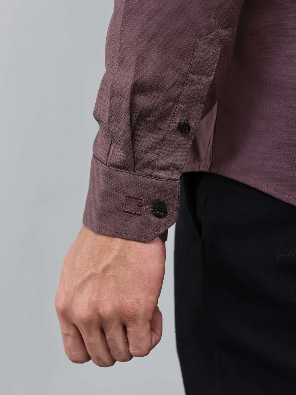 close up shot of the cuff sleeve of the contour textured dusty rose shirt