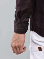 close up shot of the cuff sleeve of the midnight noir (black) maroon shirt