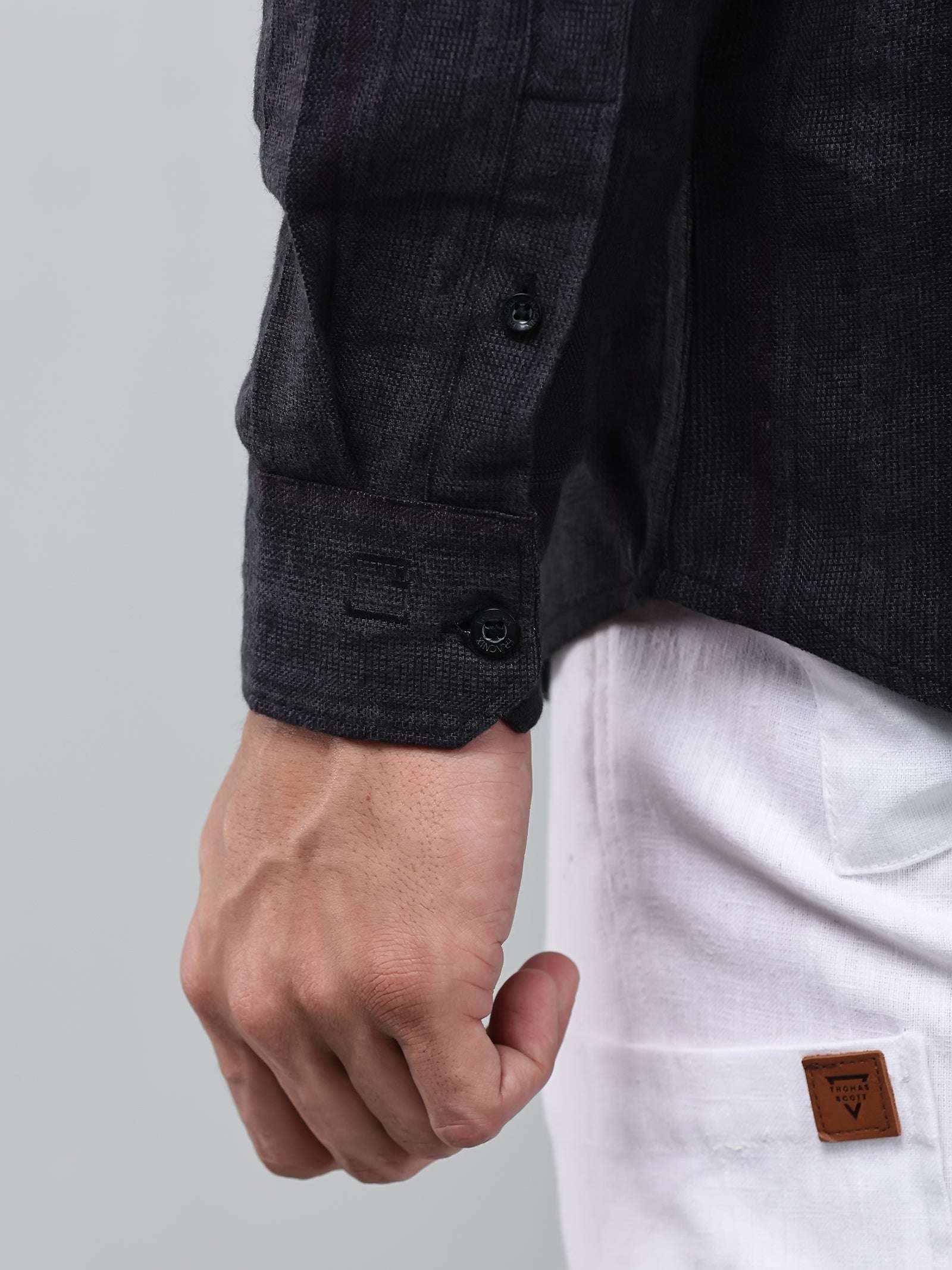 close up shot of the cuff sleeve of the midnight noir (black) obsidian shirt