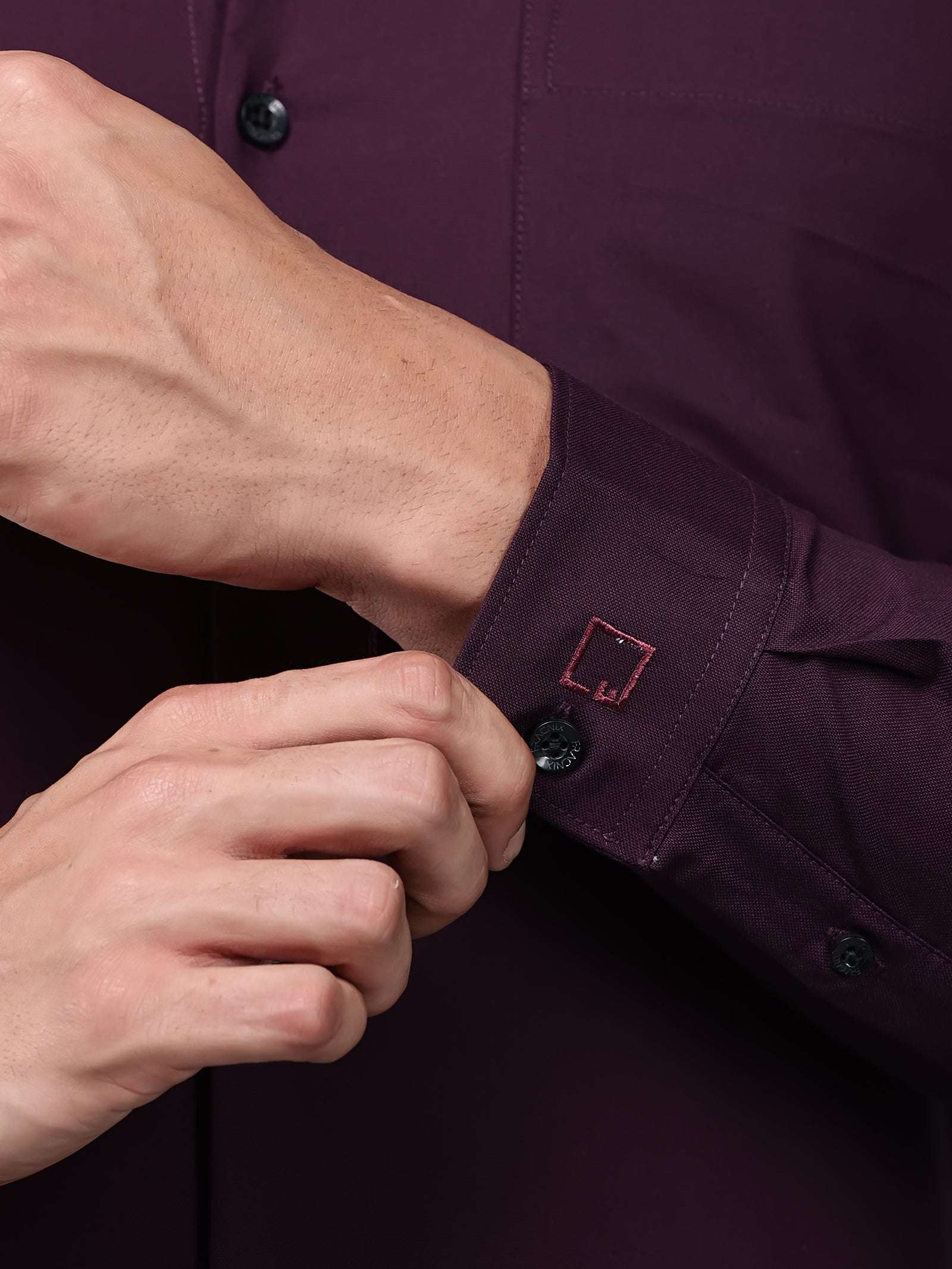 close up shot of the cuff sleeve of the signature textured stretch formal purple shirt
