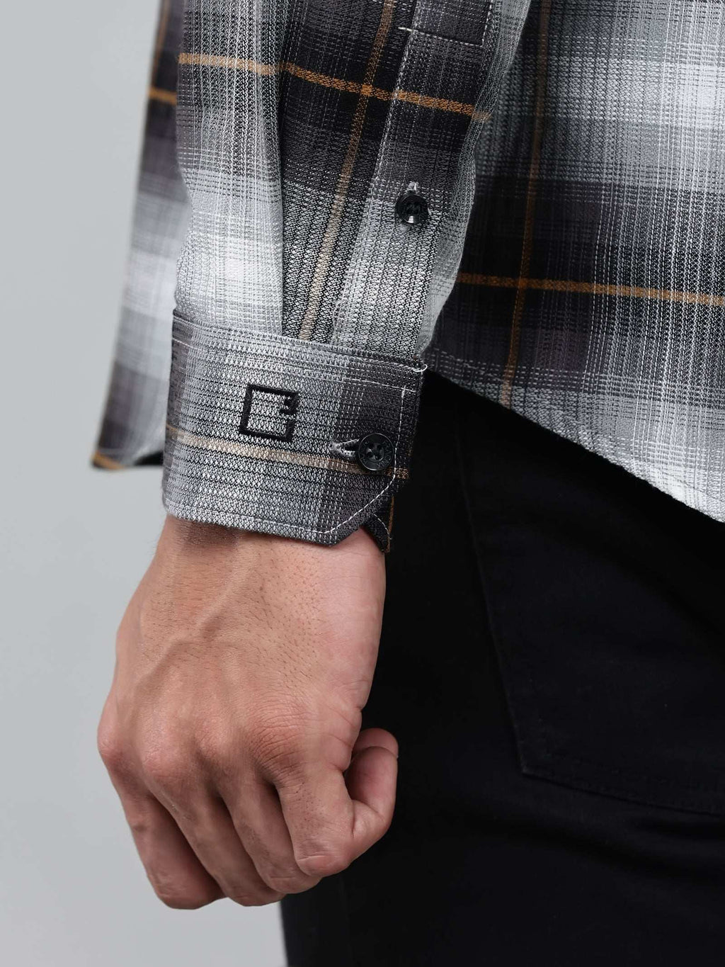 close up shot of the cuff sleeve of the graphite gradient checkered shirt