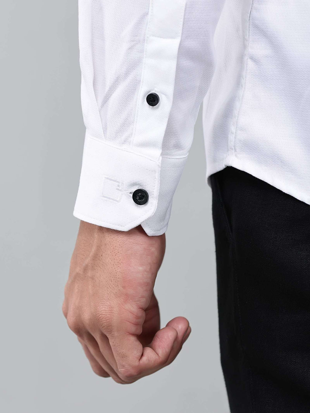 close up shot of the cuff sleeve of the contour textured classy white shirt