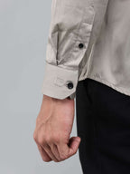 close up shot of the cuff sleeve of the luxe satin ivory stone shirt