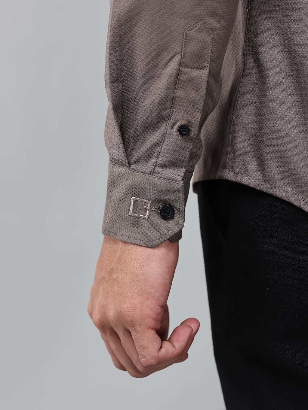 close up shot of the cuff sleeve of the contour textured smoky mauve shirt