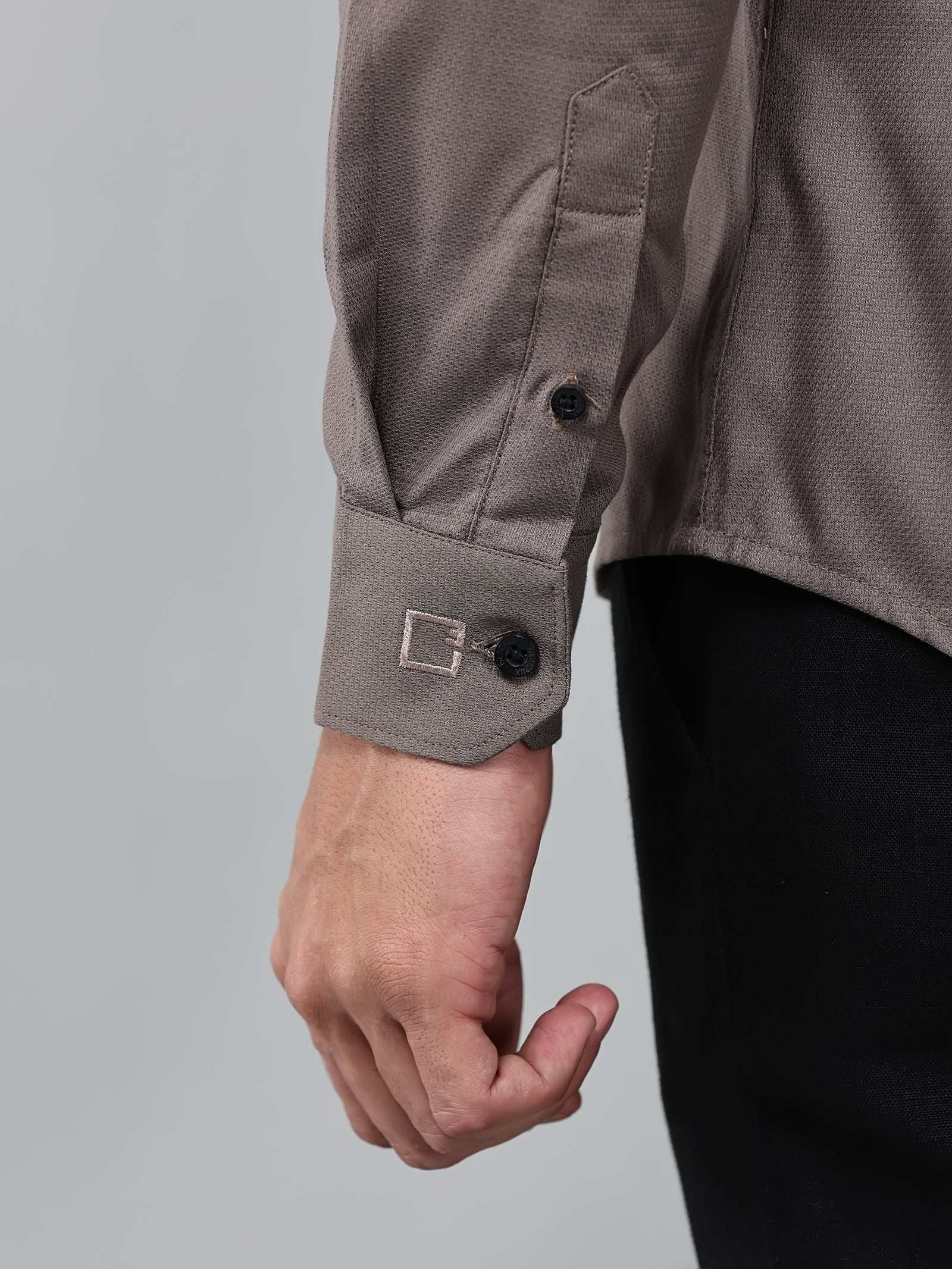 close up shot of the cuff sleeve of the contour textured smoky mauve shirt
