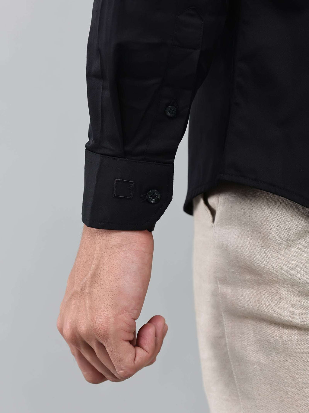 close up shot of the cuff sleeve of the luxe satin black shirt