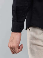 close up shot of the cuff sleeve of the luxe satin black shirt