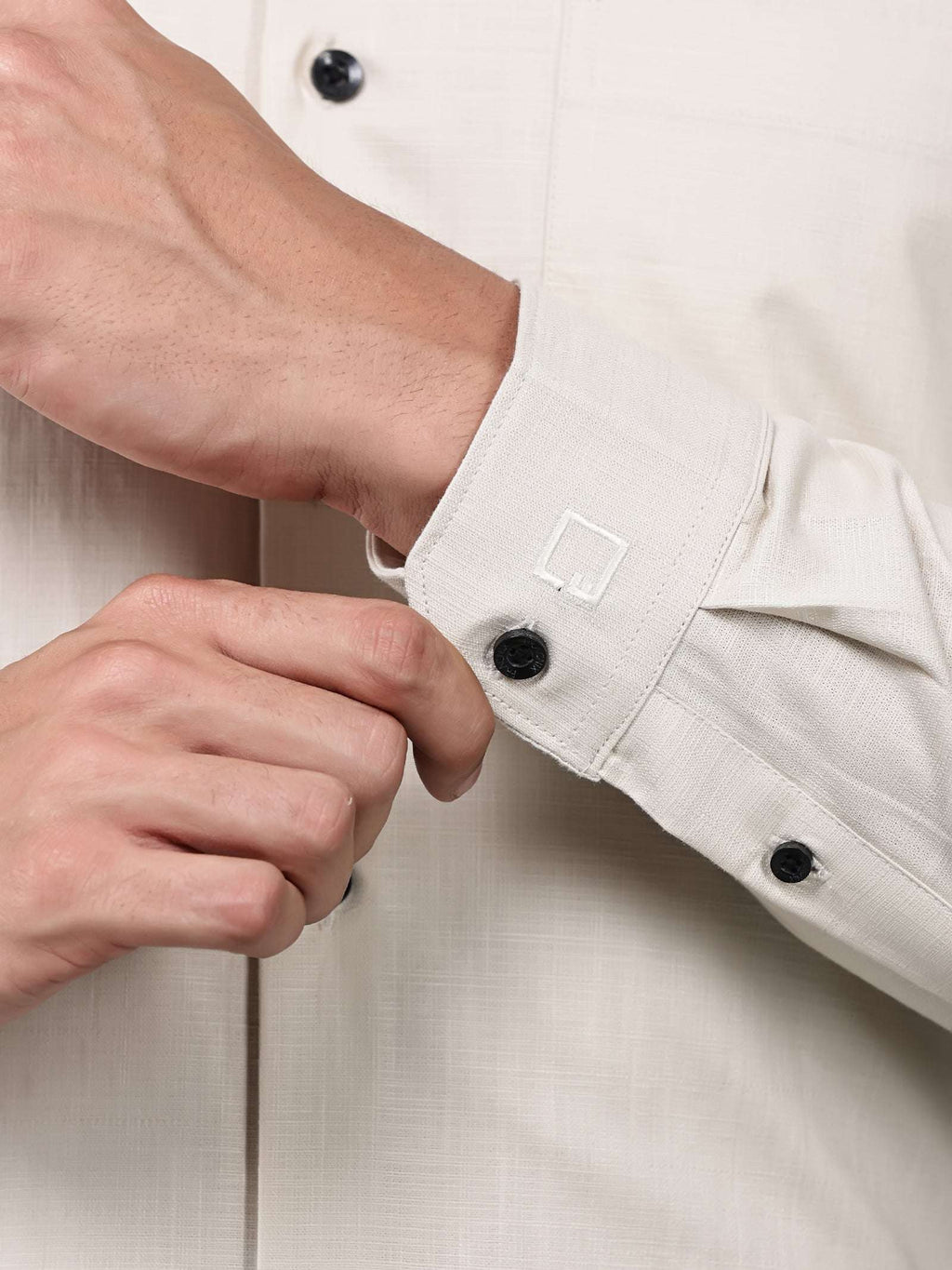 a close up shot of a cuff sleeve of a beige heritage linen luxe shirt